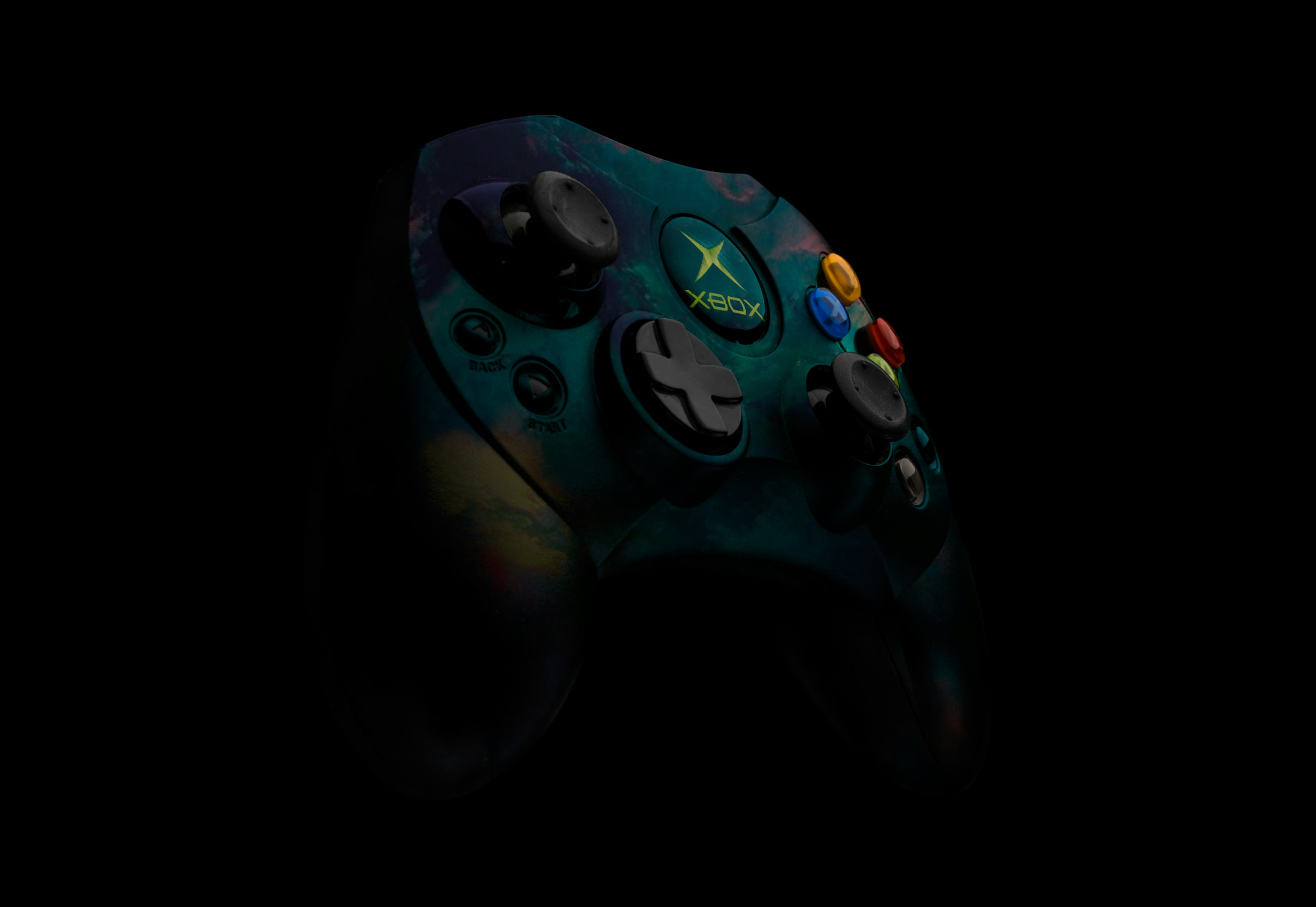 Original Xbox controller lit in teal against a black backdrop