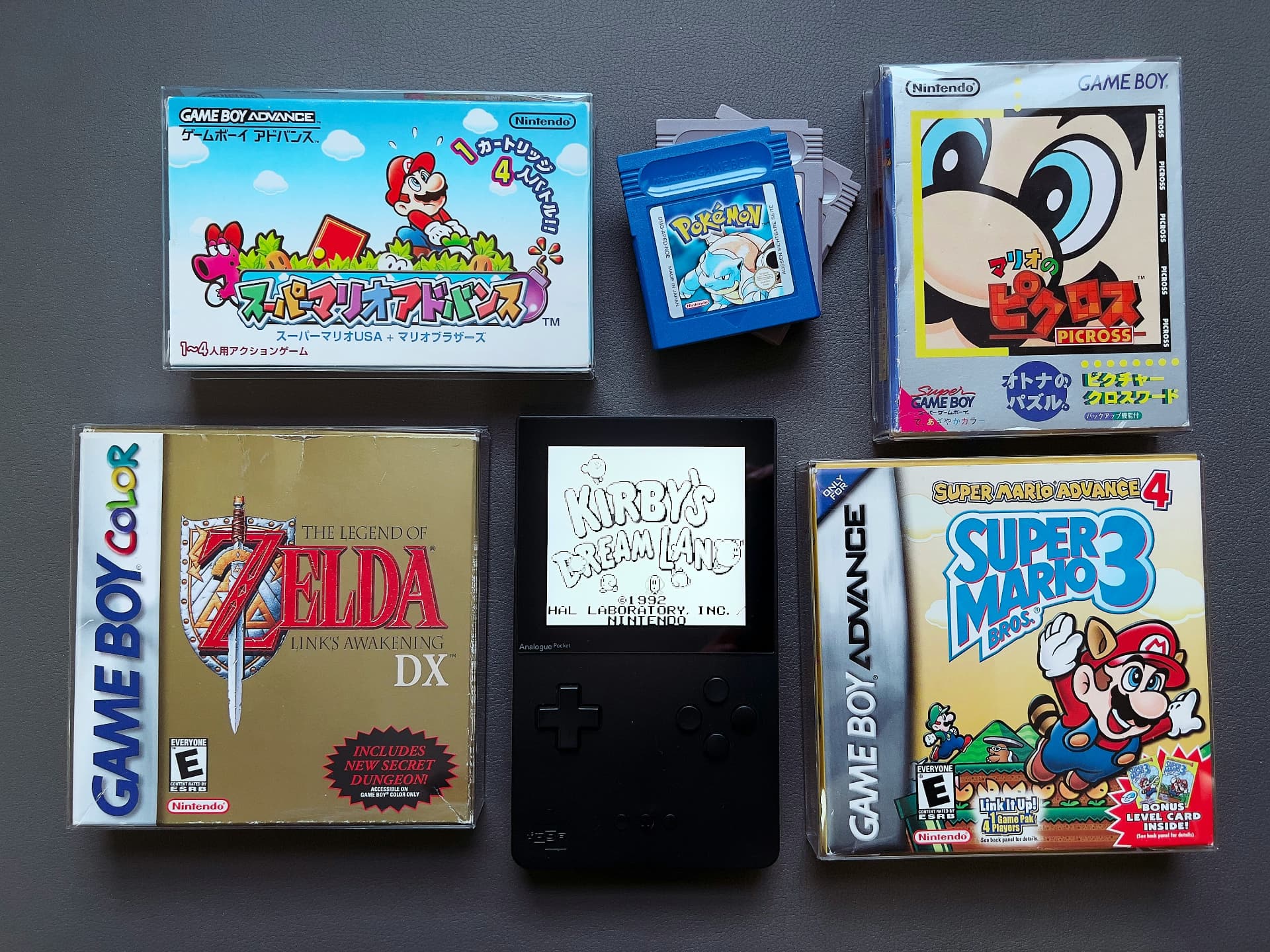 Complete-in-box Game Boy, Game Boy Color and Game Boy Advance titles laid out with an Analogue Pocket