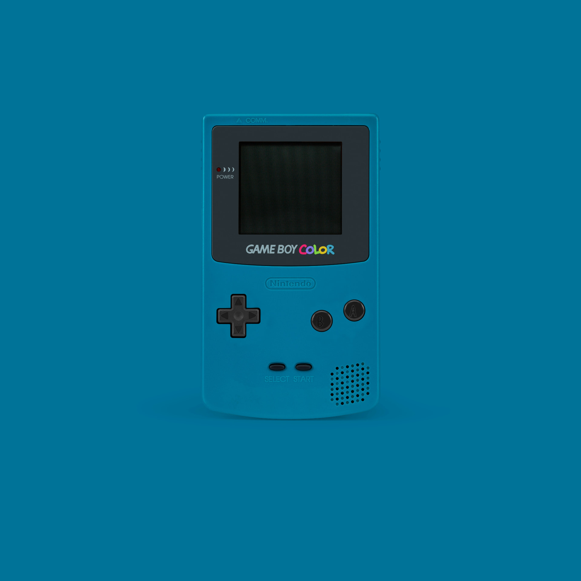 Teal Game Boy Color photographed against a deep blue backdrop